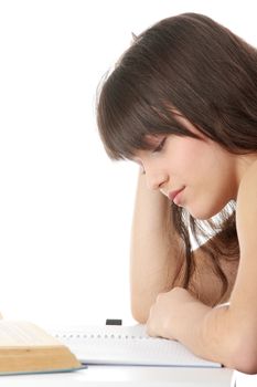 Teen girl learning at the desk, isolated on white