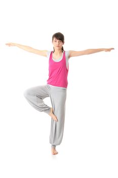 Teen woman training yoga, isolated on white