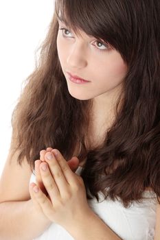Closeup portrait of a young caucasian woman praying isolated on white background