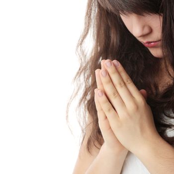 Closeup portrait of a young caucasian woman praying isolated on white background