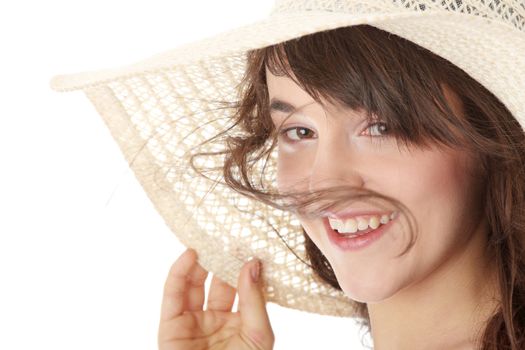Happy teen girl in dress and summer hat, over white background