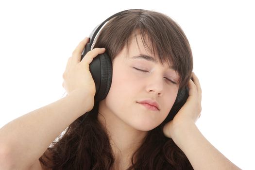 Young beautiful happy women listening music in headphones