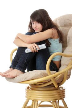 Teen woman watching TV with remote control while sitting on armchair view from TV