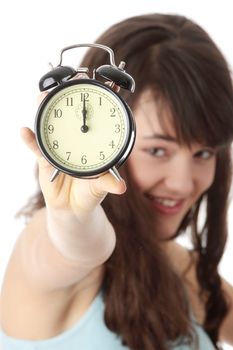 A teen woman with alarm clock isolated on white background