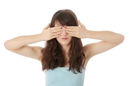 Young teen woman covering her eyes isolated on white background