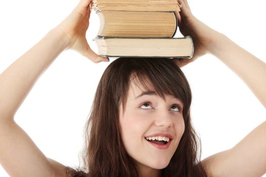 Teen student girl with lot of heavy books isolated on white background