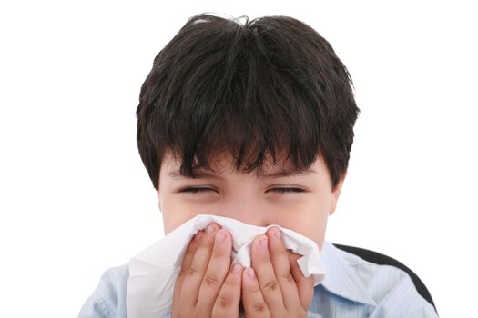 sick boy blowing his nose, white background