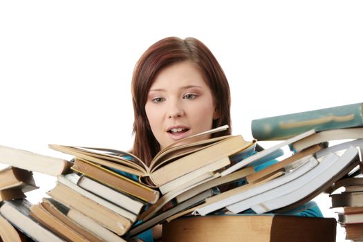 Young woman behind books, isolated on white background