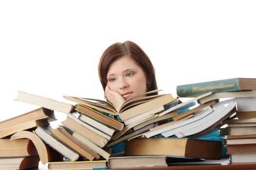 Young woman behind books, isolated on white background