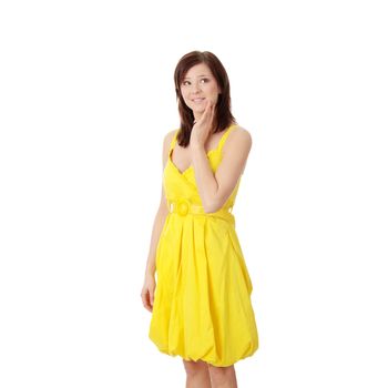 Beautiful brunette girl in yellow dress. Isolated on white background