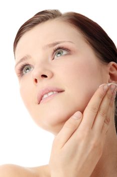 Woman applying moisturizer cream on face. Close-up fresh woman face.
