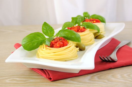 Nest of spaghetti with tomato and basil dressing