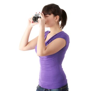 Pretty girl making photo using classic slr camera. Isolated on white
