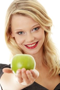 Young blond woman with green apple on her hand - healthy eating concept