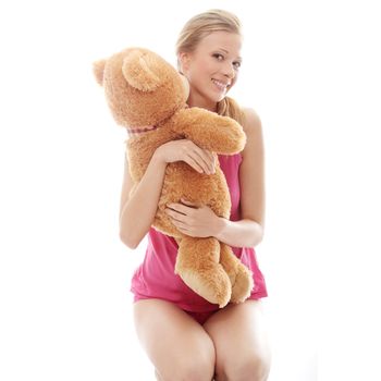 Teen girl with teddy bear, isolated on white background