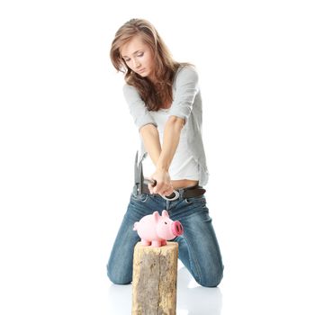 Young woman with hammer about to smash piggy bank to get at corporate savings