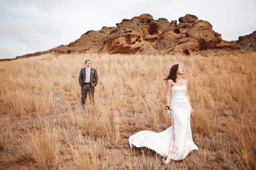 couple in the field near the mountains