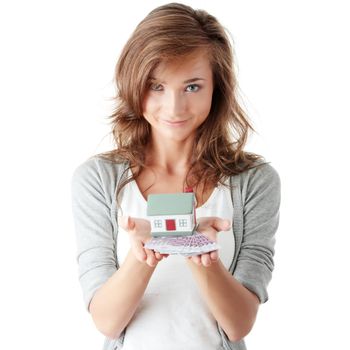 Beautiful young woman holding euros bills and house model over white - real estate loan concept