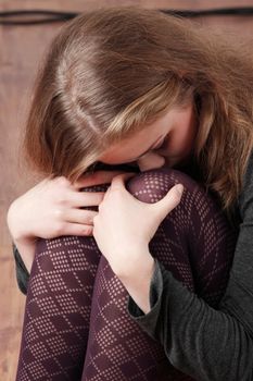 Sad or depressed woman sitting on the flor