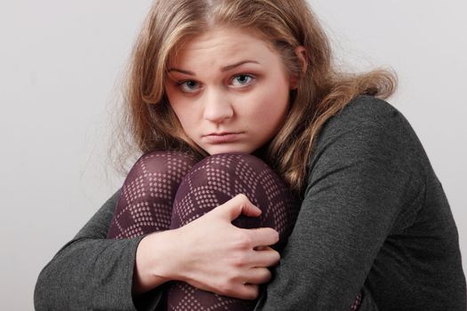 Sad or depressed woman sitting on the flor