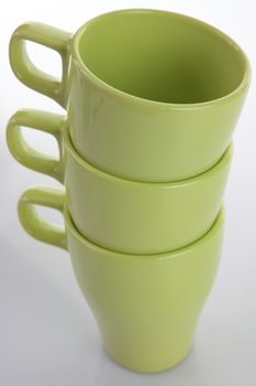 Three empty green mugs isolated