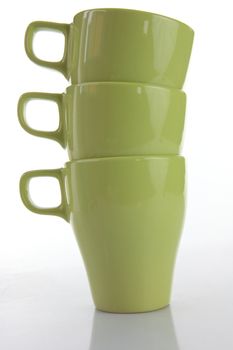 Three green mugs isolated on white