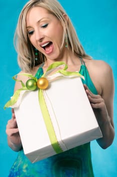 A blonde adult female woman's expression of delight of receiving a gift or present