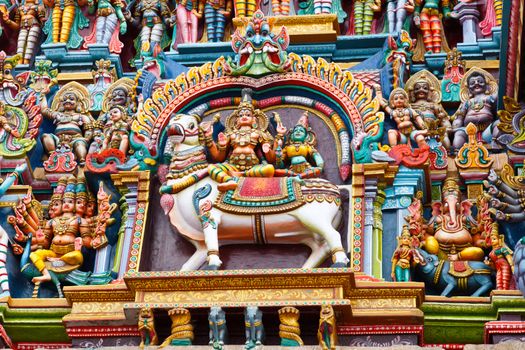 Shiva and Parvati on bull images. Sculptures on Hindu temple gopura (tower). Menakshi Temple, Madurai, Tamil Nadu, India