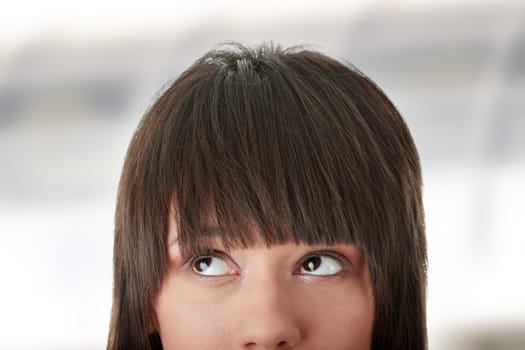 Cropped image of a young girl with her eyes looking away left
