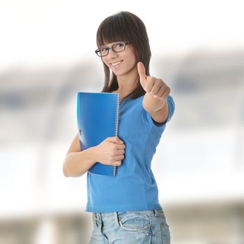 Teen student girl with note pad gesturing OK