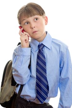 A child student using a mobile phone cellphone to catch up with friends.  White background.