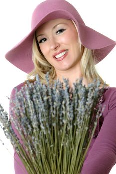 A female holding a bunch of dried lavender in her hands, 