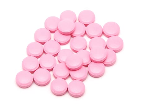 Pink tablets on a white background