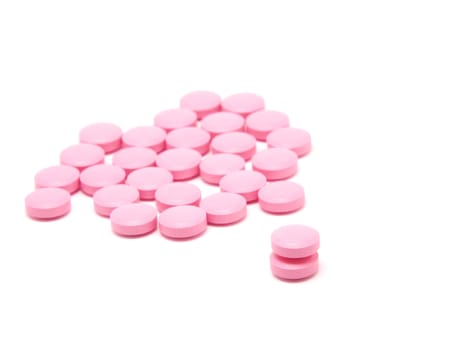 Pink tablets on a white background