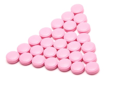 Pink tablets on a white background