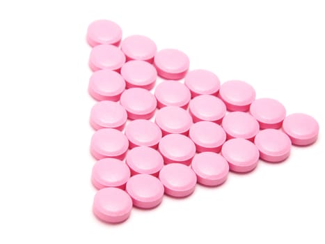 Pink tablets on a white background