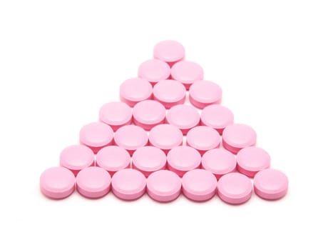 Pink tablets on a white background