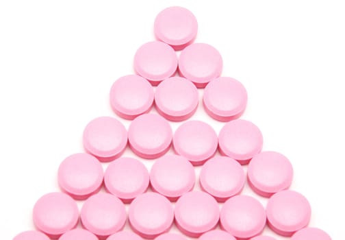 Pink tablets on a white background