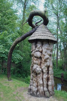 Intresting wooden sculpture made of few unusual trees near stream