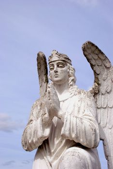 Sculpture of white angel praying for good to all world