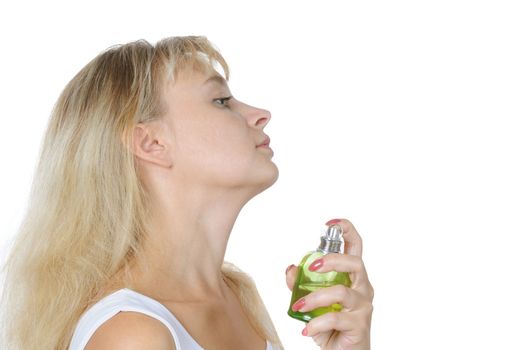 Sensual blond woman applying perfume on her body