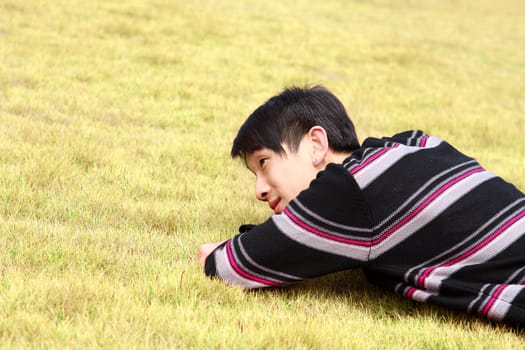 Young man lying on grass 
