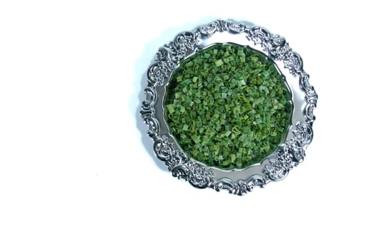 Dried chives on a silver plate