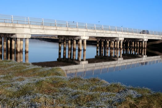 bridge over a calm cold river in kerry ireland on a frosty morning