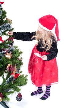 Beautiful baby girl dressed up for Christmas isolated in white