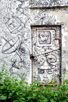 Doors and wall drawn of original rhythmic graffiti