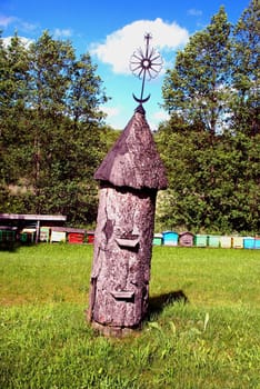 Beekeeping heritage - ancient vertical hive decorated with antique metal ware