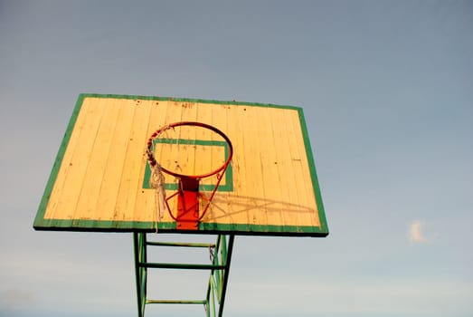 Basketball board with an old tattered net on the hoop