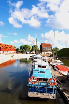 Yachts resting in docks with lowered sails