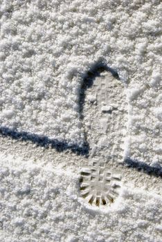 Human foot and bicycle wheel imprint in the snow